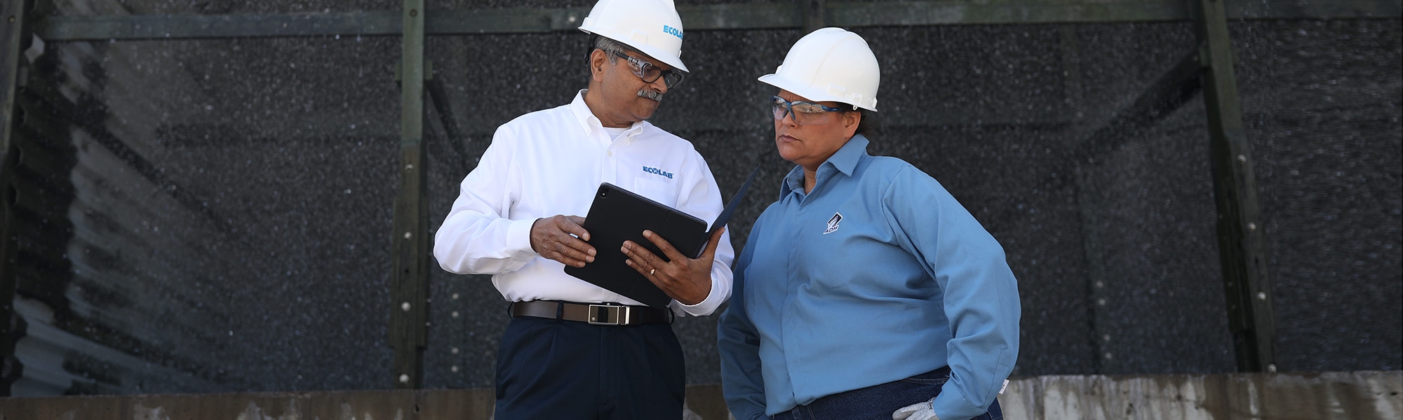 Ecolab Expert talking with a client at a water treatment plant